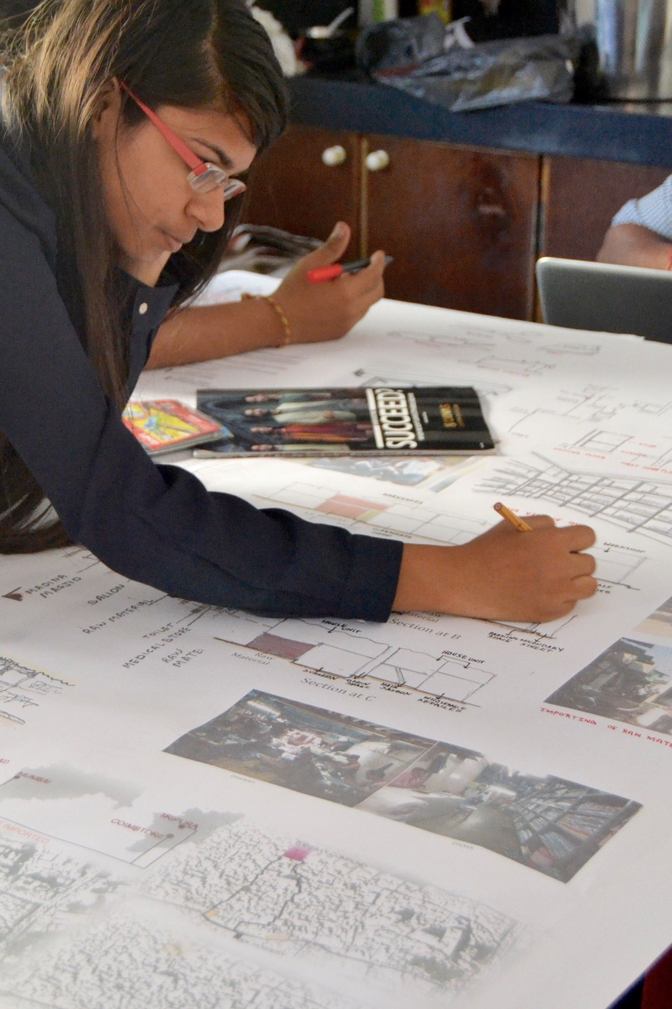 Careful, final touches on the display material before the exhibition.