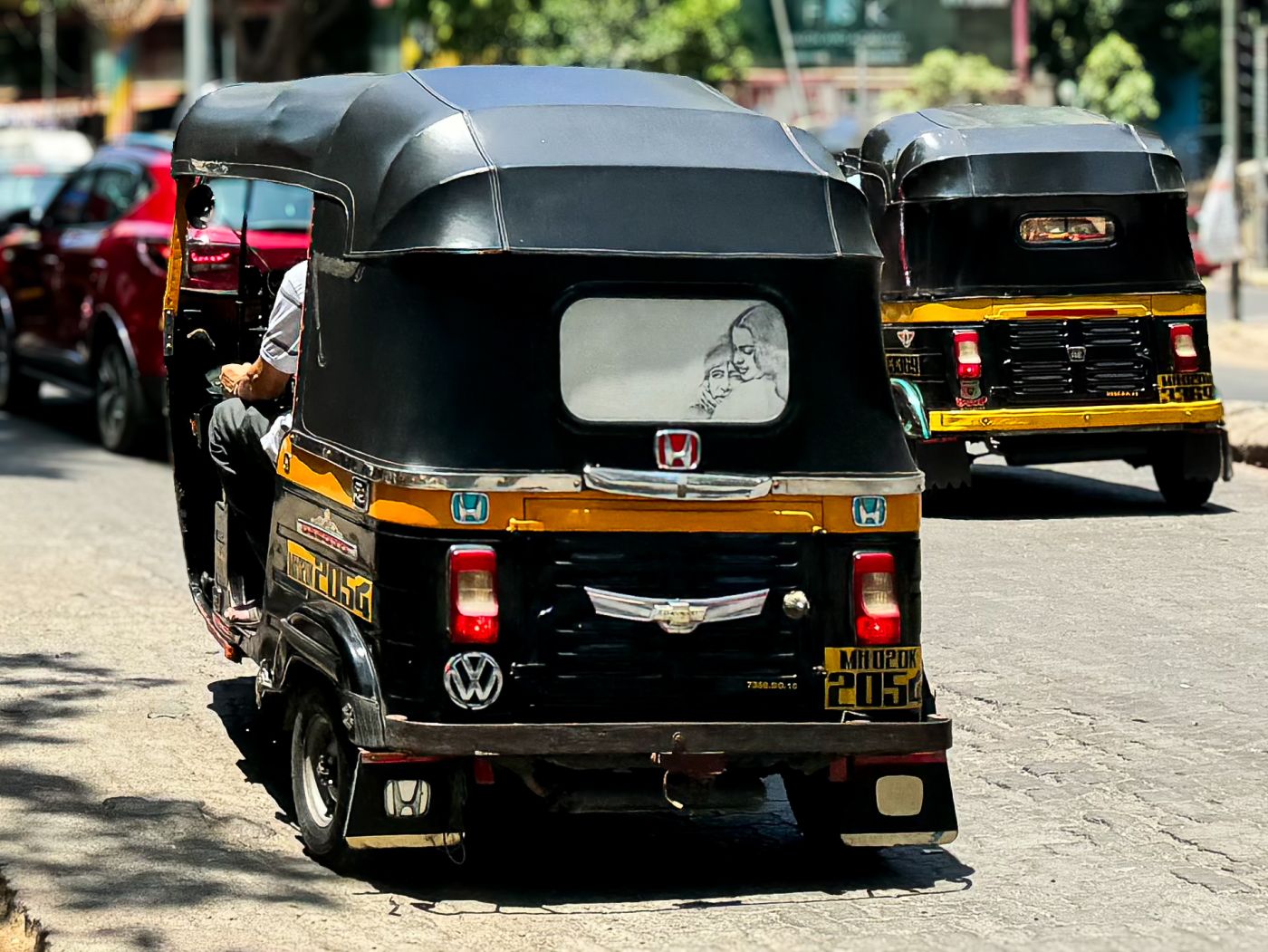 An autorickshaw showcasing multiple brand logos (Photo Credit : Paarth Vedak)