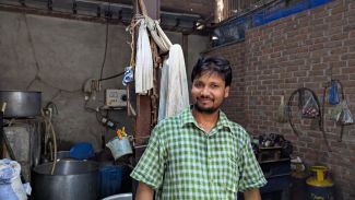 Shahid standing in his workspace