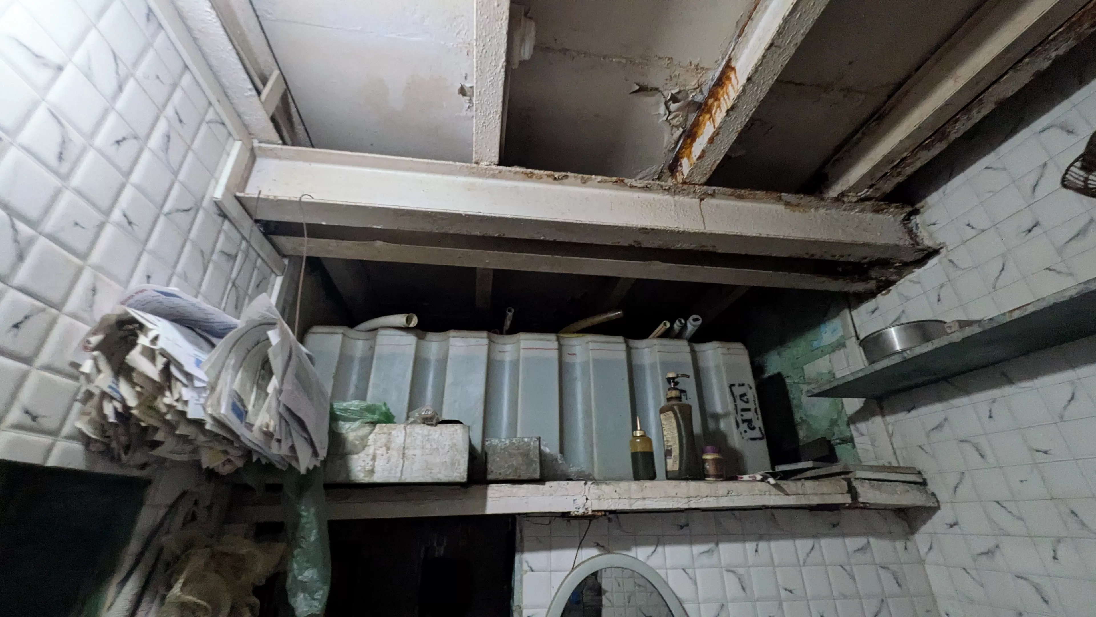 Structural elements showing the effects of age and long-term use inside Paarasmal Jain's home.