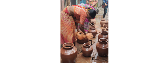  Woman polishing the pots after they have dried, getting them ready to be fired in the kilns