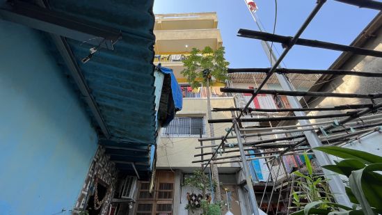 View of Vithal Bhaskar chawl (in yellow) from the alley