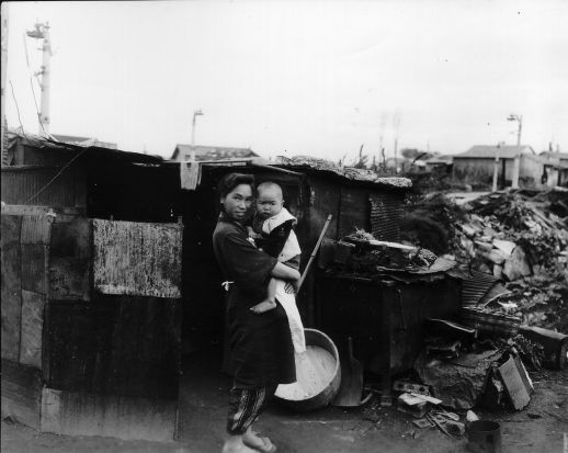 Woman and child outside bombed home in Ebisu, Tokyo