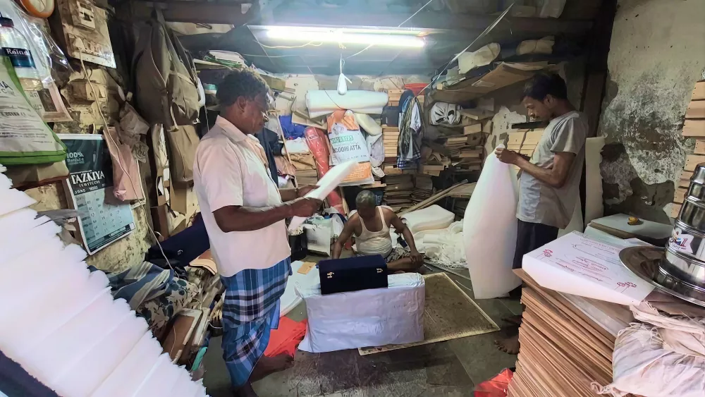 Bashir instructing his workers in his workshop