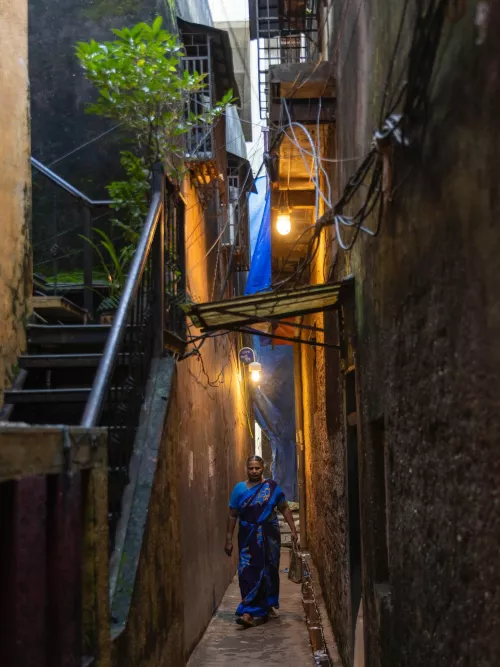 Update on Solar Street Light Project

The solar street lighting for Dharavi Koliwada is an incremental civic infrastructure project. After designing and installing bespoke streetlights, we are now connecting the lights to solar energy.

Making this connection involved months of surveying several terraces in the neighbourhood to find the one with the best combination of space, height and orientation for the solar panels. Next came a round of discussions with the residents and the Dharavi Koli Jamat to negotiate a fair exchange for the use of their terrace. It was decided to produce extra solar energy to subsidise residents’ electricity bills.

The installation of the panels is underway, and the lights will be solar-powered in a matter of
weeks!

Photos:

1. Streetlights in action.

2. Surveying locations with the highest potential to generate solar energy

3. Discussions between Chandrakant Koli, who has a solar installation business, and the
resident, whose terrace was found to be most suitable.

4. The terrace is used to dry fish. The placement of solar panels was carefully planned to accommodate fish drying on the terrace. Drying of fish is an important seasonal activity and ensures that seafood is part of the diet even when outside of the fishing season.

5,6. Inauguration of the installation project
Solar panels being transported and carefully hoisted up to the terrace, each panel
weighs about 30 kgs!

7. Dutta Koli, a local fabricator, puts up the supporting framework for the panels.

8. The team, including friends and neighbours help with the installation 

9. Chandrakant Koli and Santosh Salgaonkar of Solar Power Systems and Solutions, the team responsible for execution of the project.