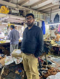 Khurshid Bhai, and his workshop in the background