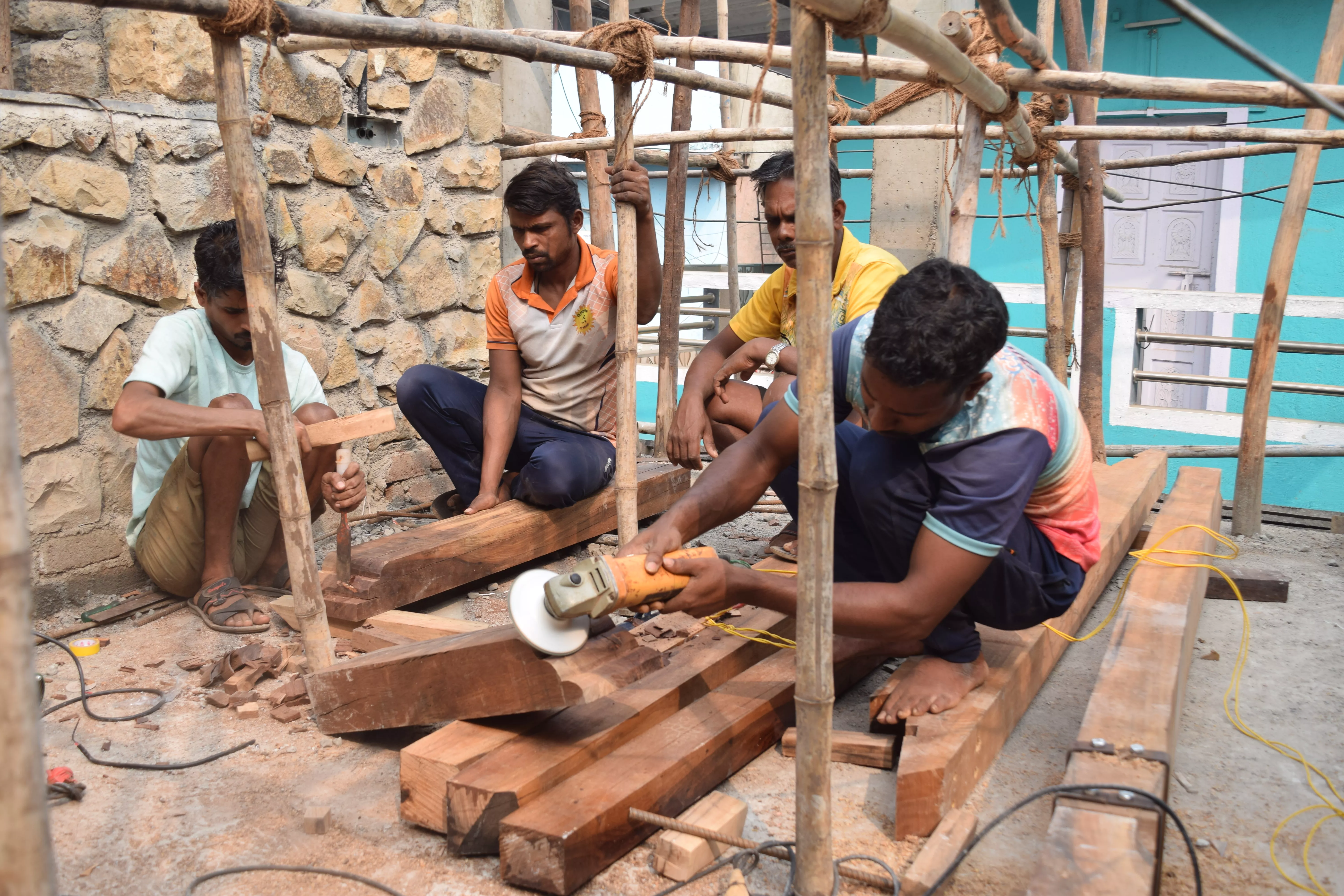 Wood craftsmen at work on the rafters and ridge