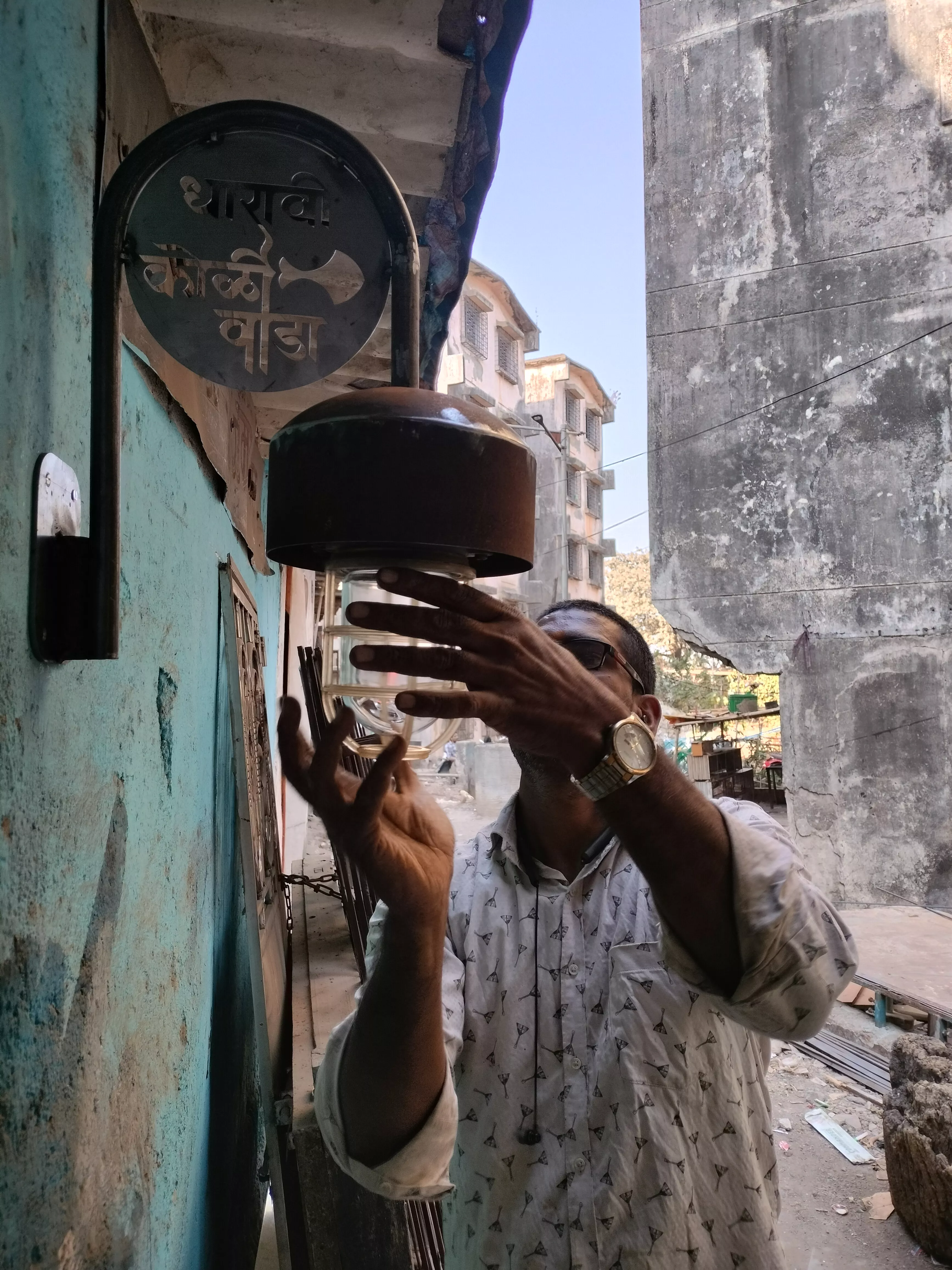 Local fabricator, Dutta Koli, fitting the ship lights into customised brackets