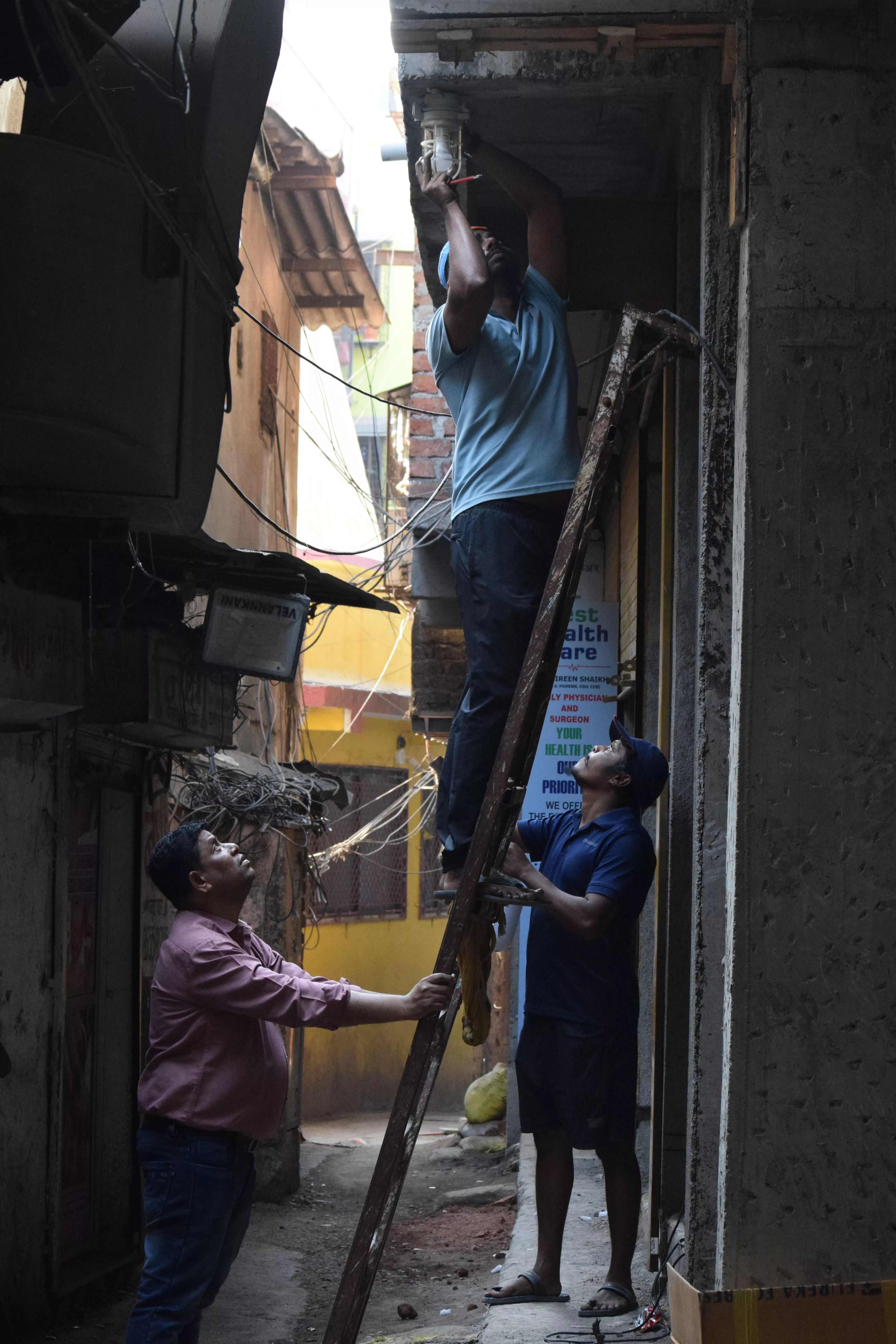 Recycled ship lights being installed in Koliwada 